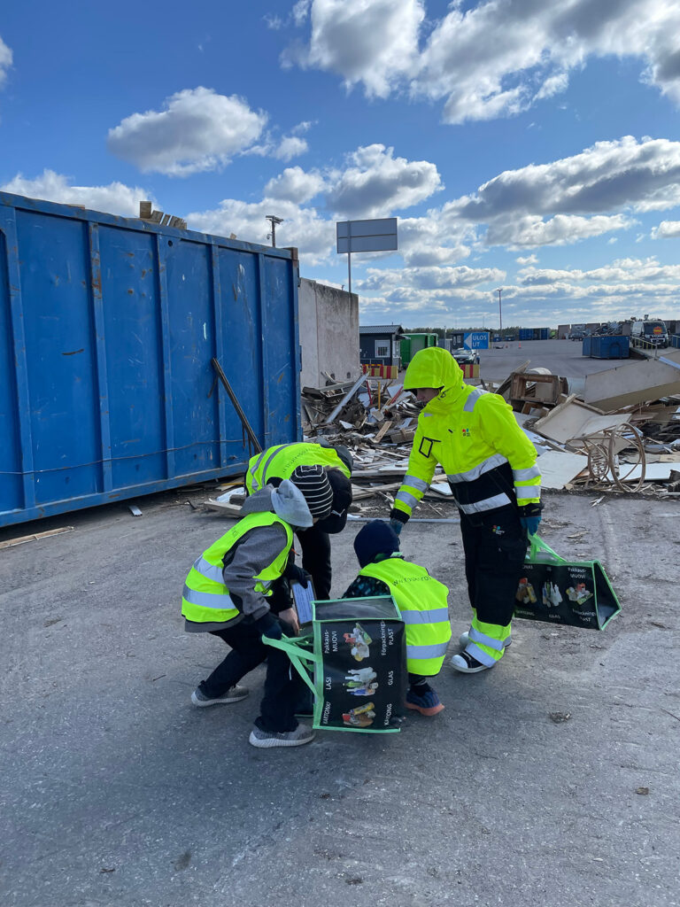 Oppilaita lajittelemassa Domargårdin jäteasemalla.